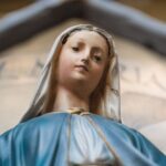 Detailed close-up of a Virgin Mary statue showcasing spiritual symbolism.